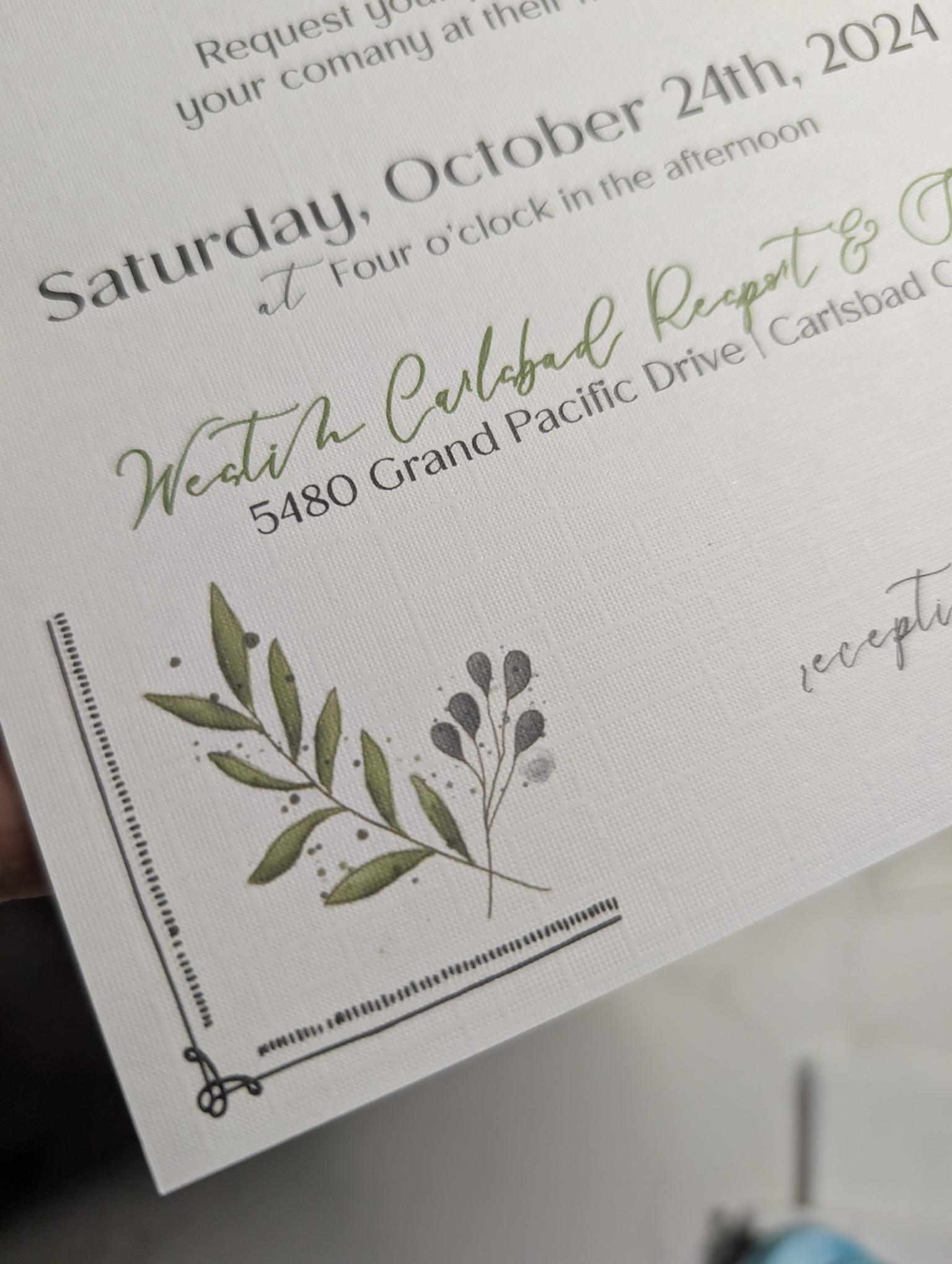 Invitation card with greenery design and text on a white background