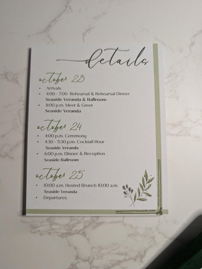 Wedding event details card with a leaf design on a marble background