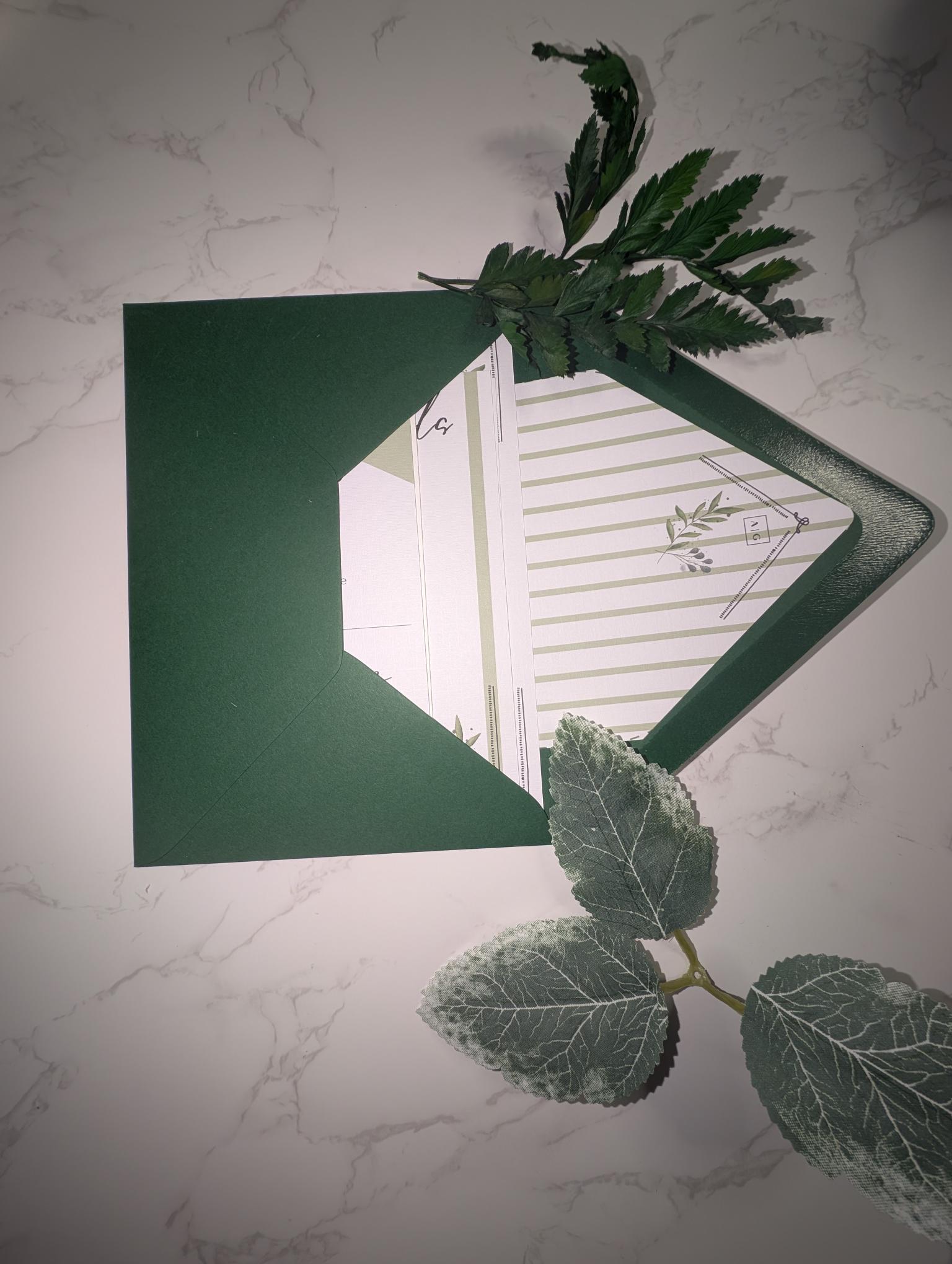 Green card with a cut-out design on a marble surface