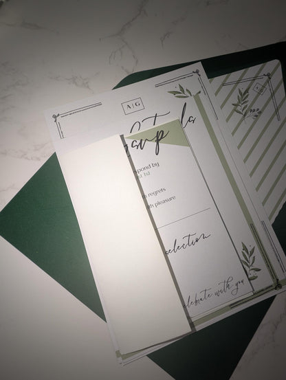 Set of stationery items with green and white design on a textured surface