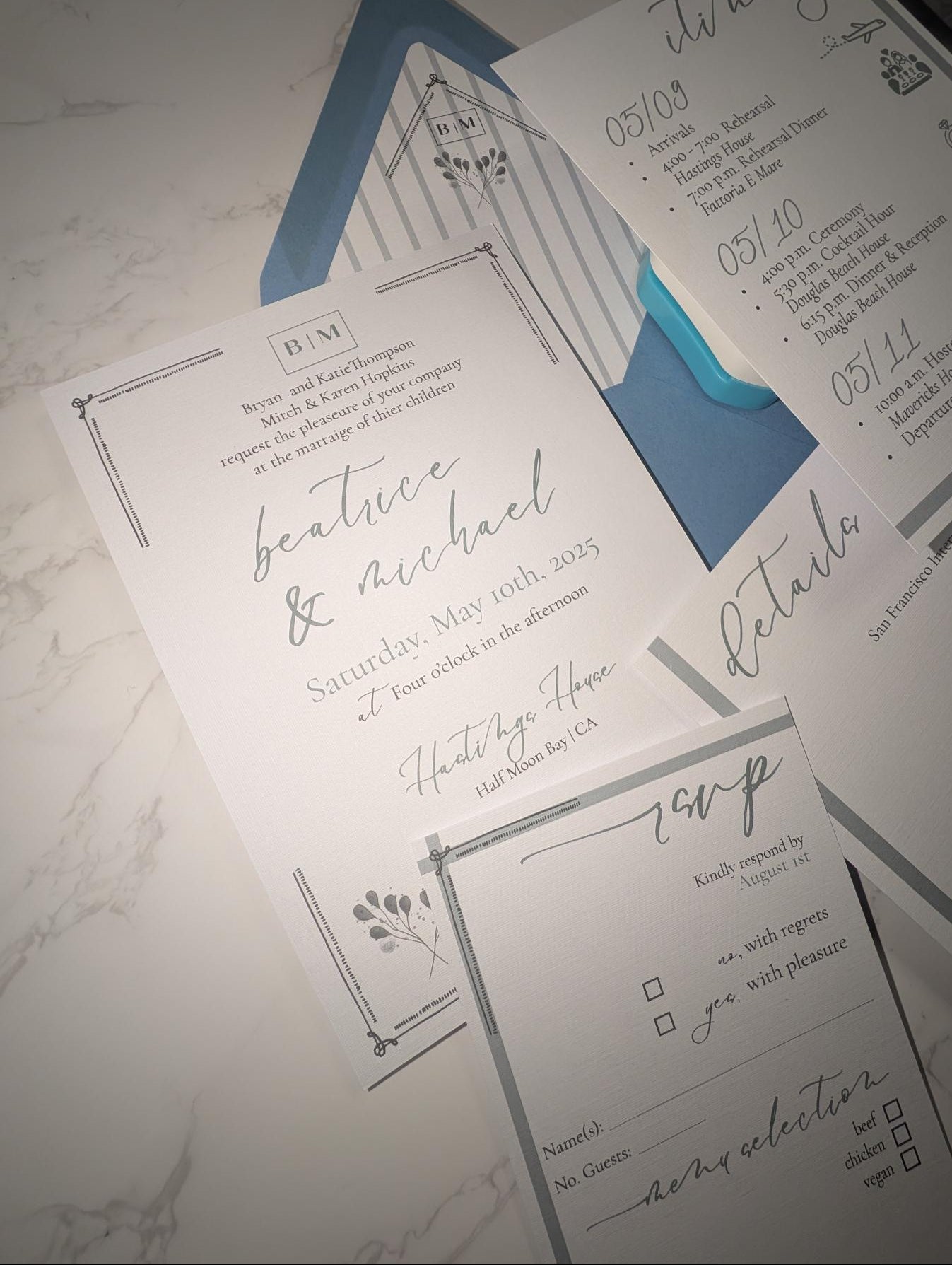 Wedding invitation set with RSVP card on a marble surface