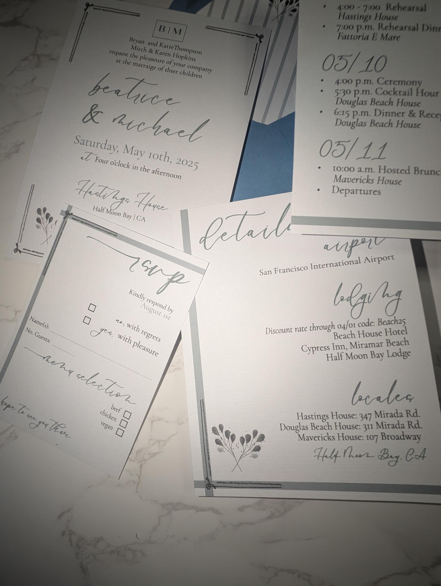 Collection of wedding invitation details on a marble surface