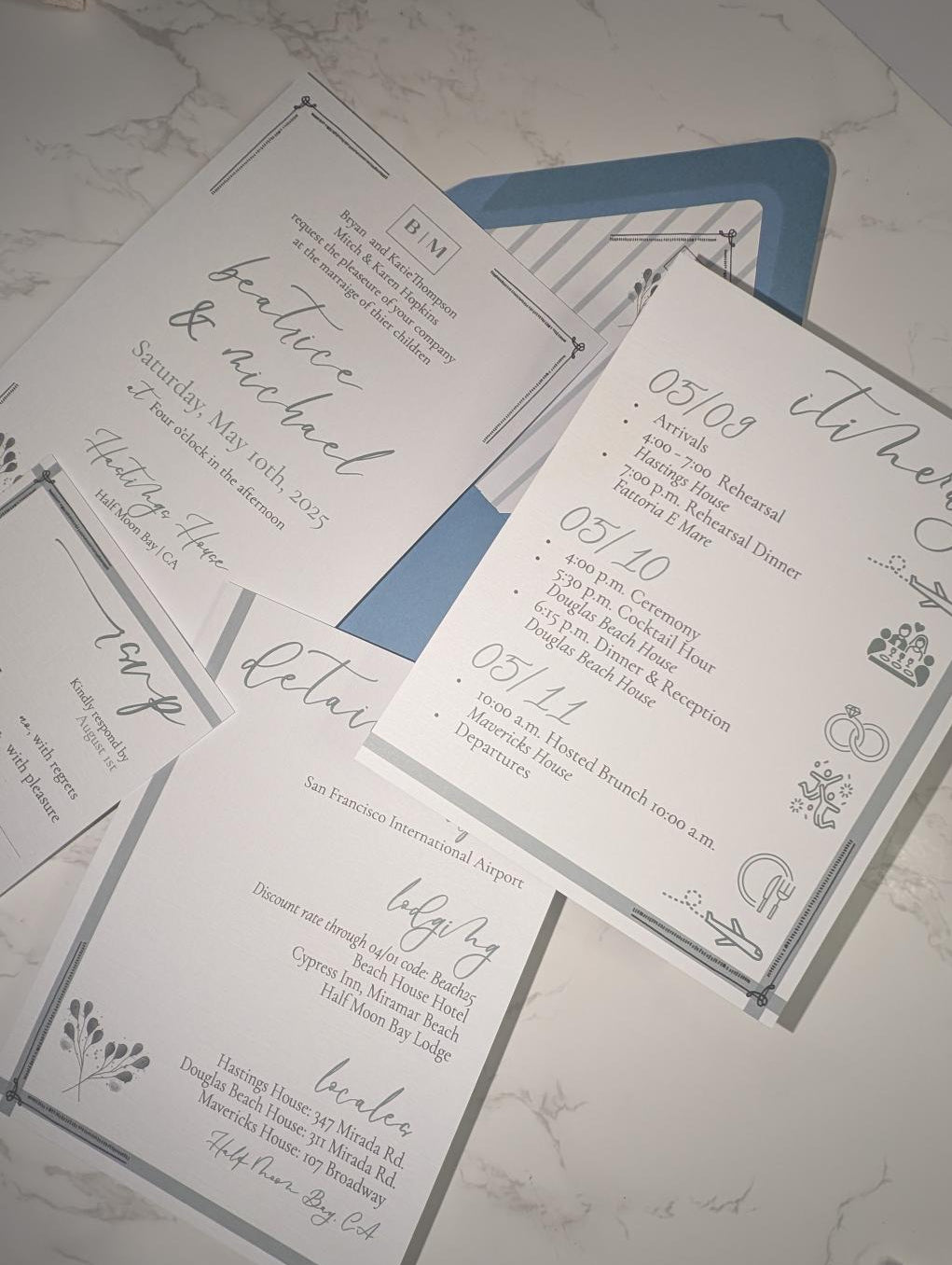 Wedding invitation cards with details on a marble surface