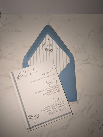 Wedding invitation with blue envelope on a marble surface