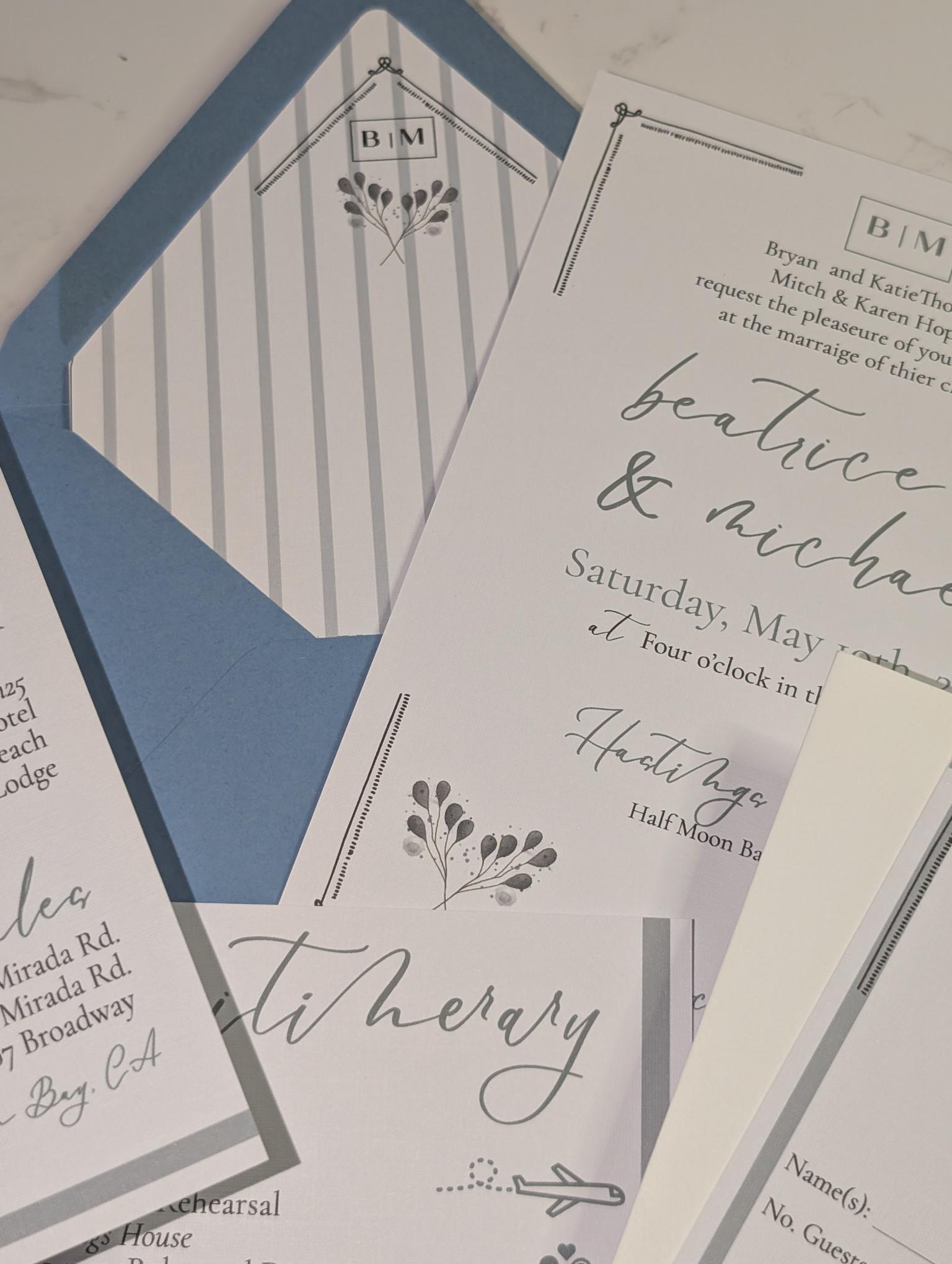 Collection of wedding invitations and stationery items on a light background
