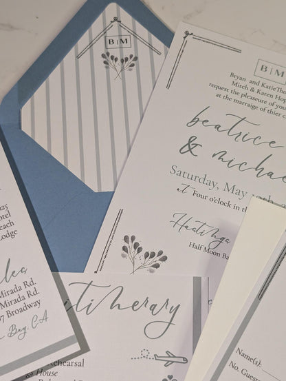 Collection of wedding invitations and stationery items on a light background