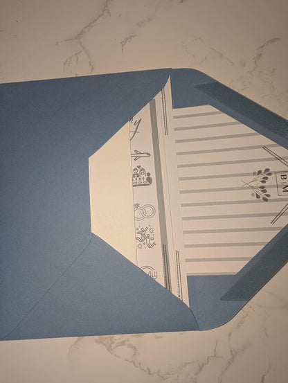 Blue envelope with a white interior design on a marble surface