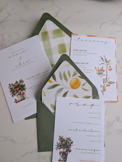 Set of wedding invitations with floral designs on a marble surface