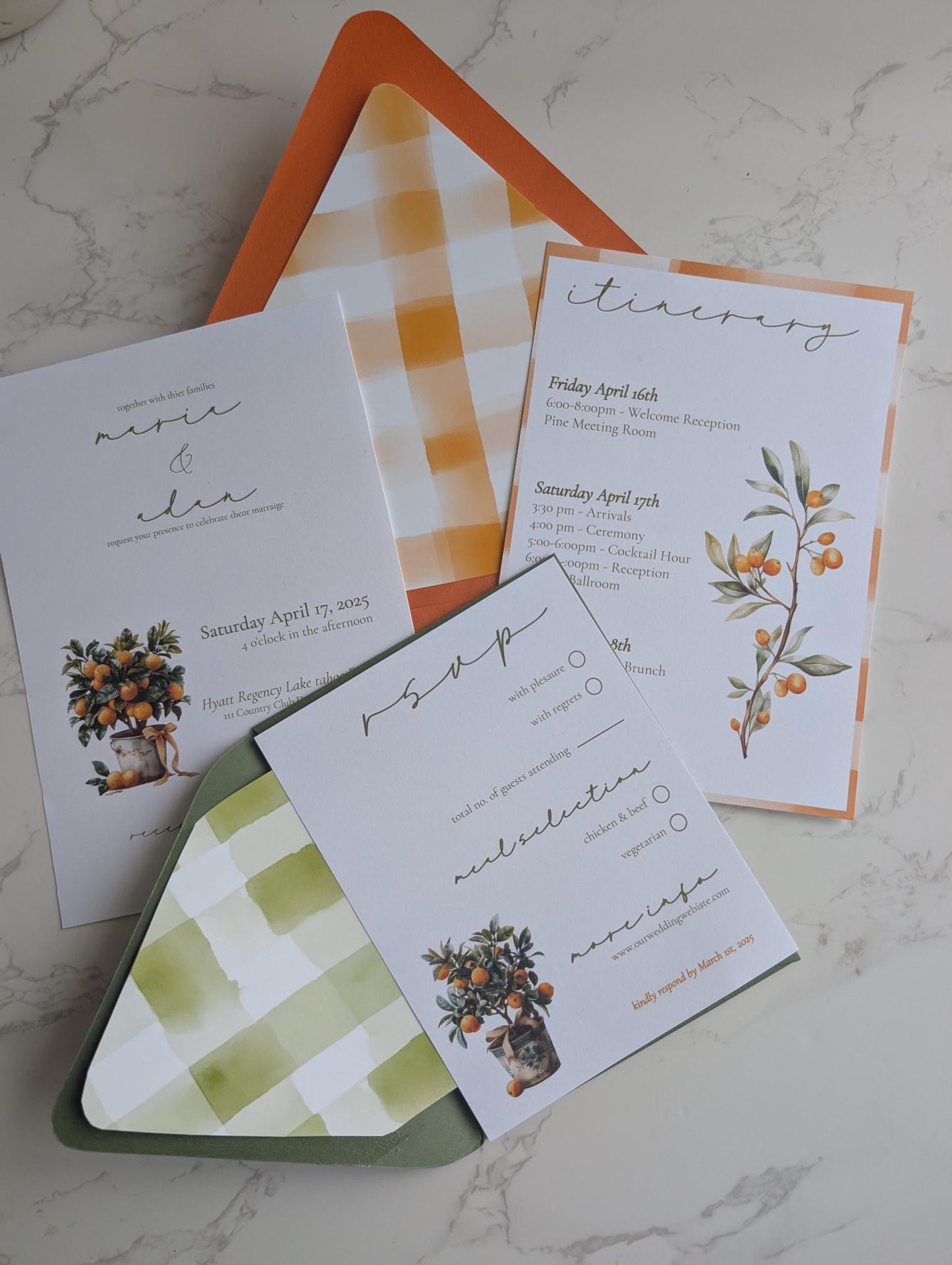 Set of wedding invitations with orange and green checkered envelopes on a marble surface