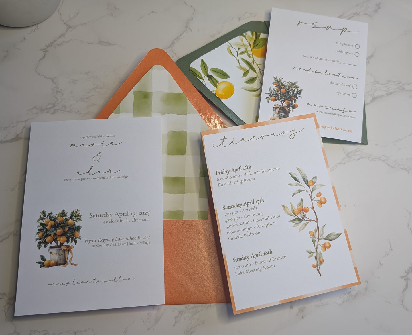 Set of wedding invitations with floral designs on a marble surface