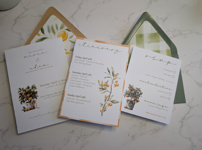 Wedding invitation set with floral designs on a marble surface