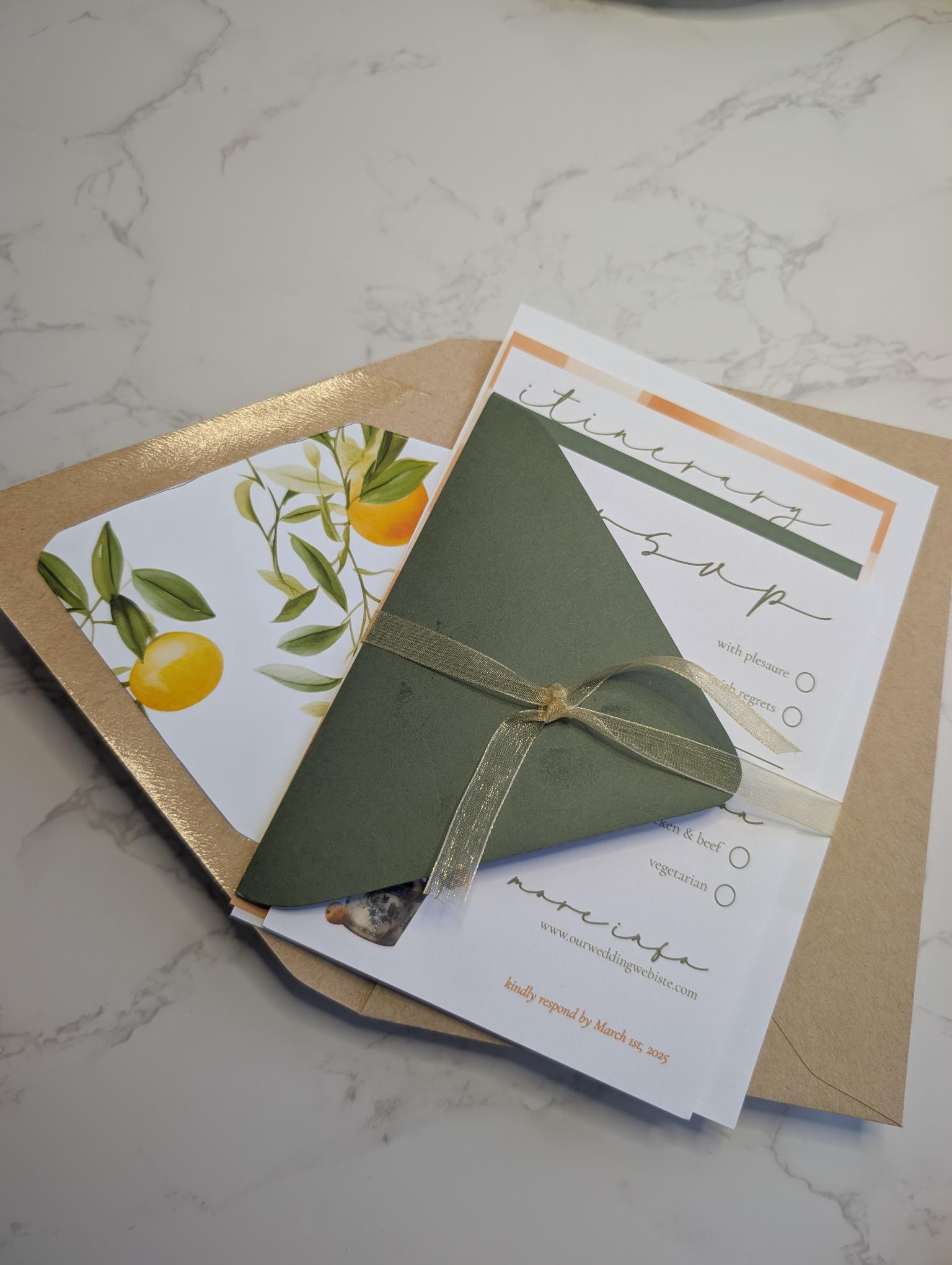 Green envelope tied with a ribbon on a marble surface