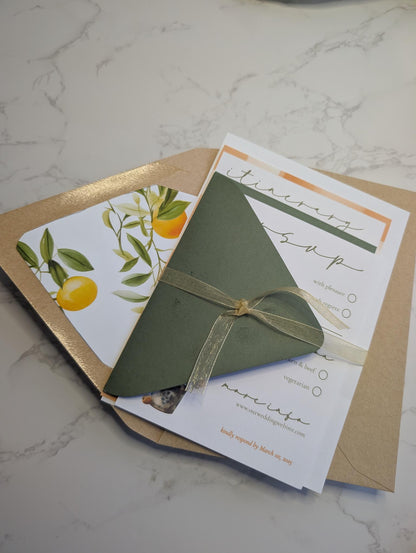 Green envelope tied with a ribbon on a marble surface