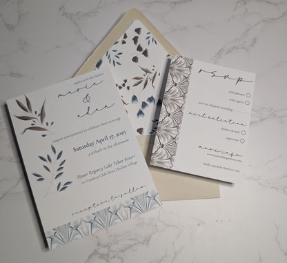 Wedding invitation and RSVP card set on a marble surface