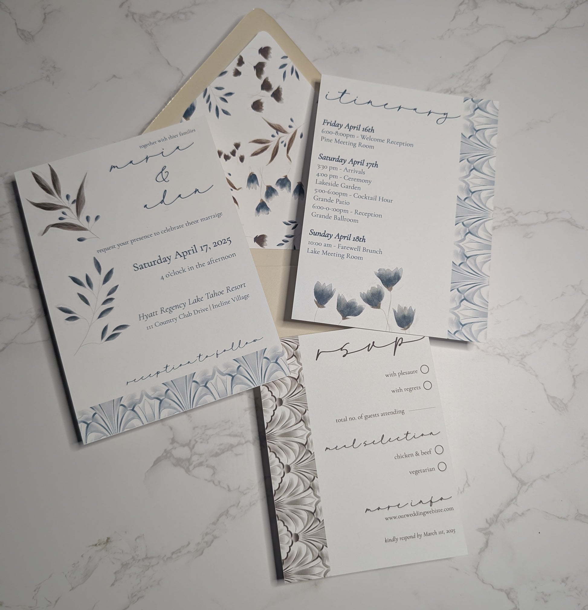 Wedding invitation set with floral designs on a marble surface
