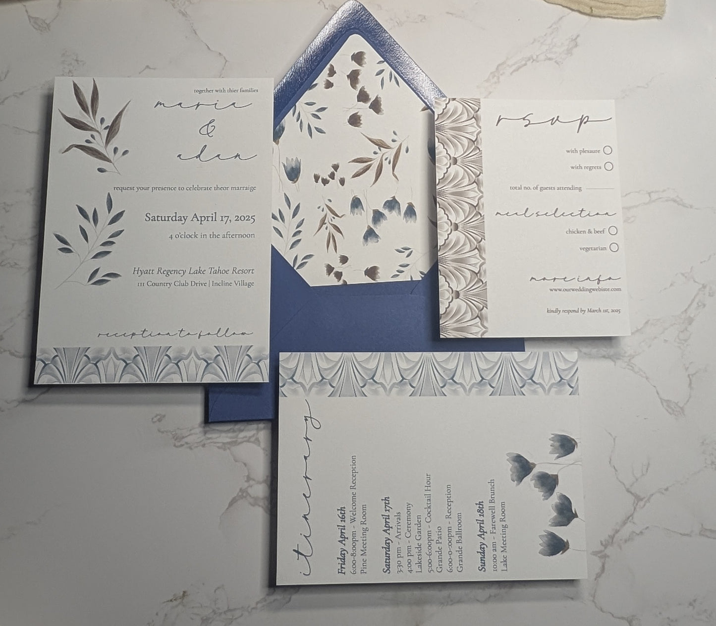 Wedding invitation set with floral designs on a marble surface