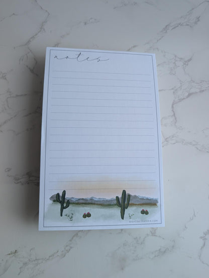 Notepad with cactus design on a marble surface