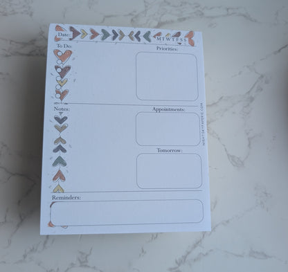 Planner sheet with daily schedule layout on a marble surface