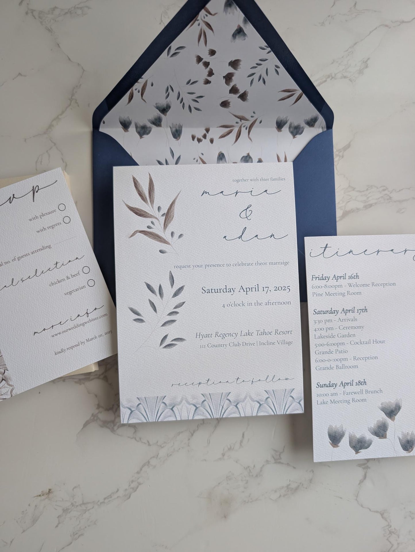 Wedding invitation set with RSVP card on a marble surface