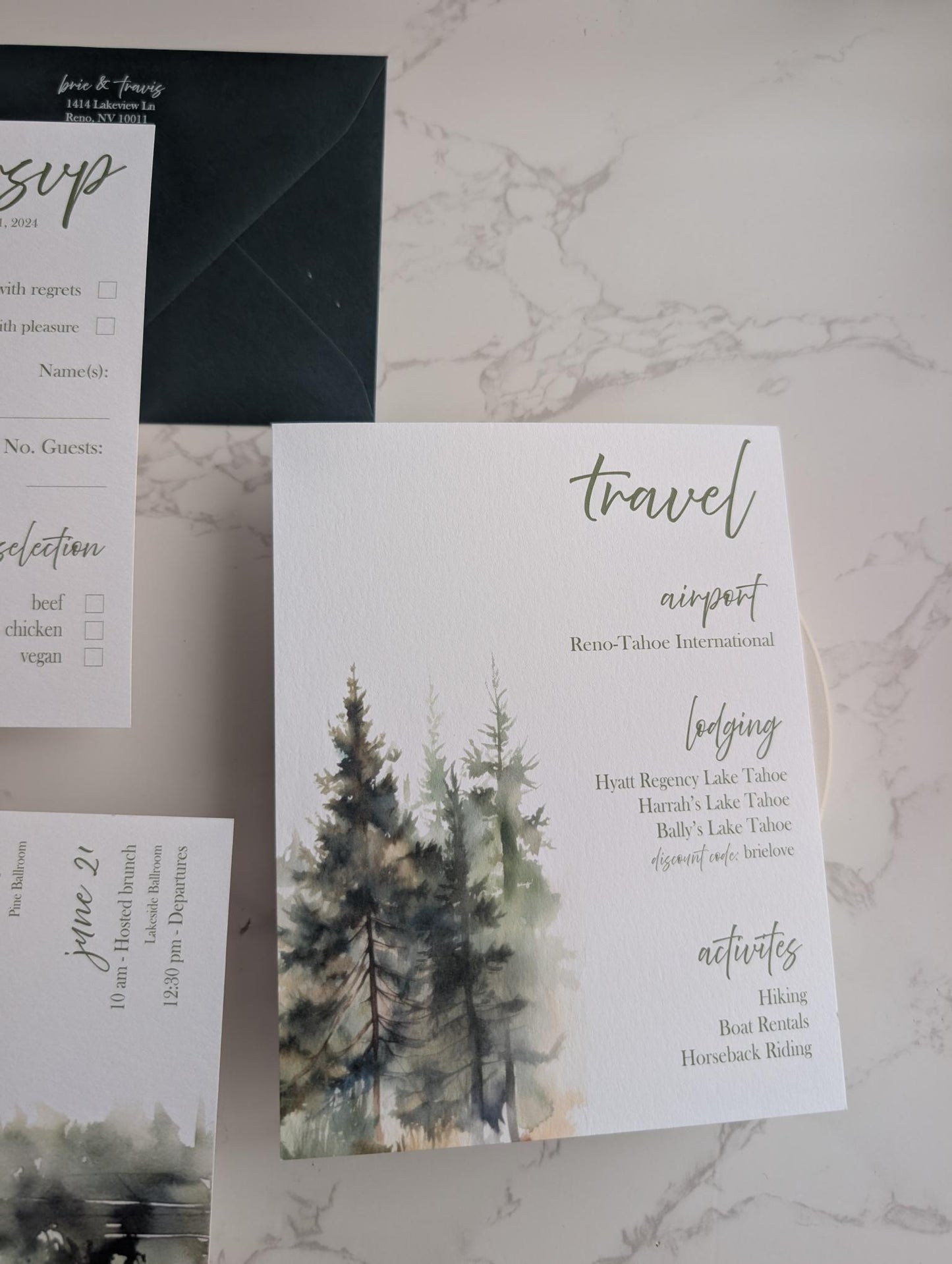 Wedding invitation suite with trees and text on a marble surface