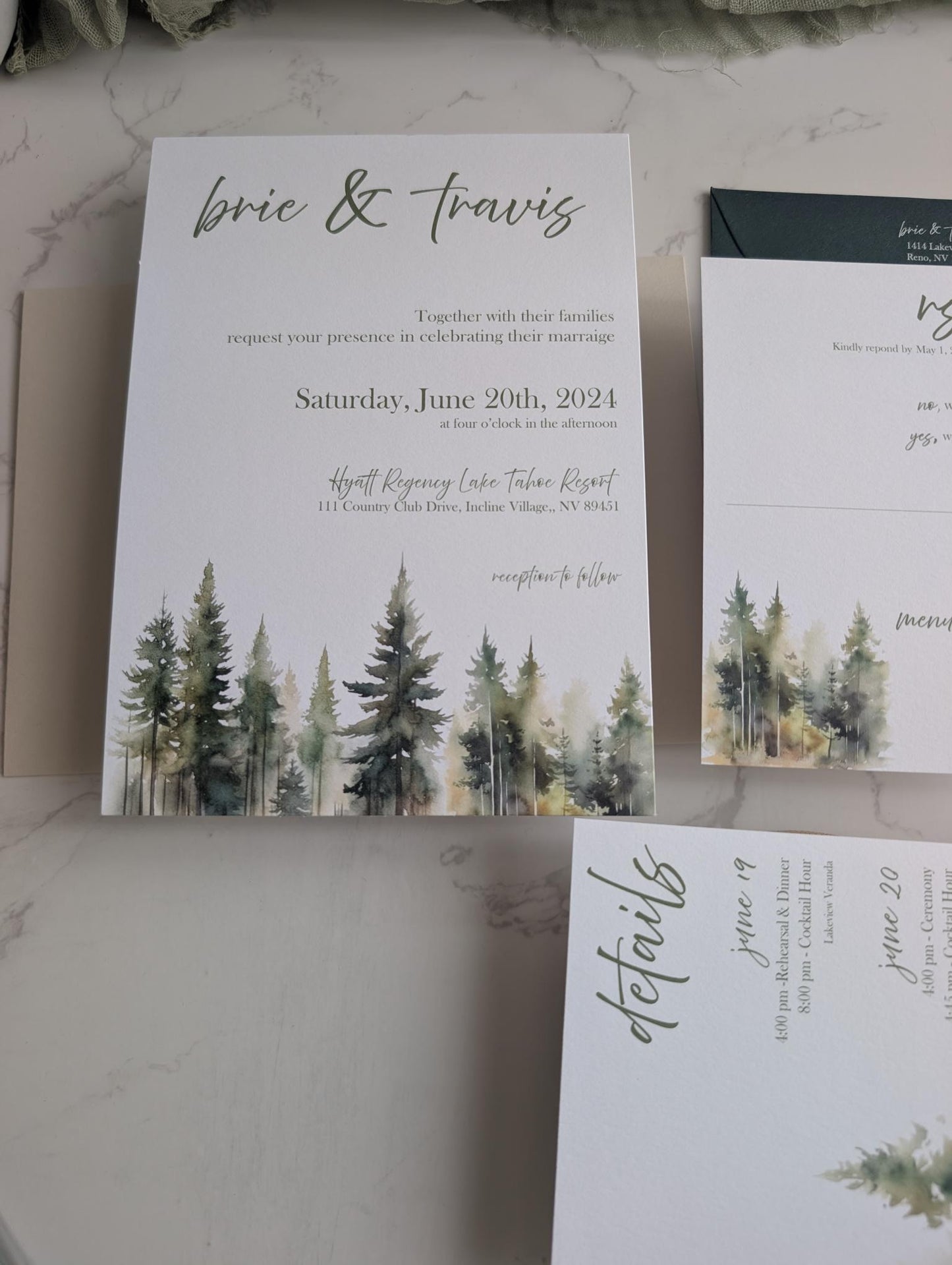 Wedding invitation with forest design on a marble surface