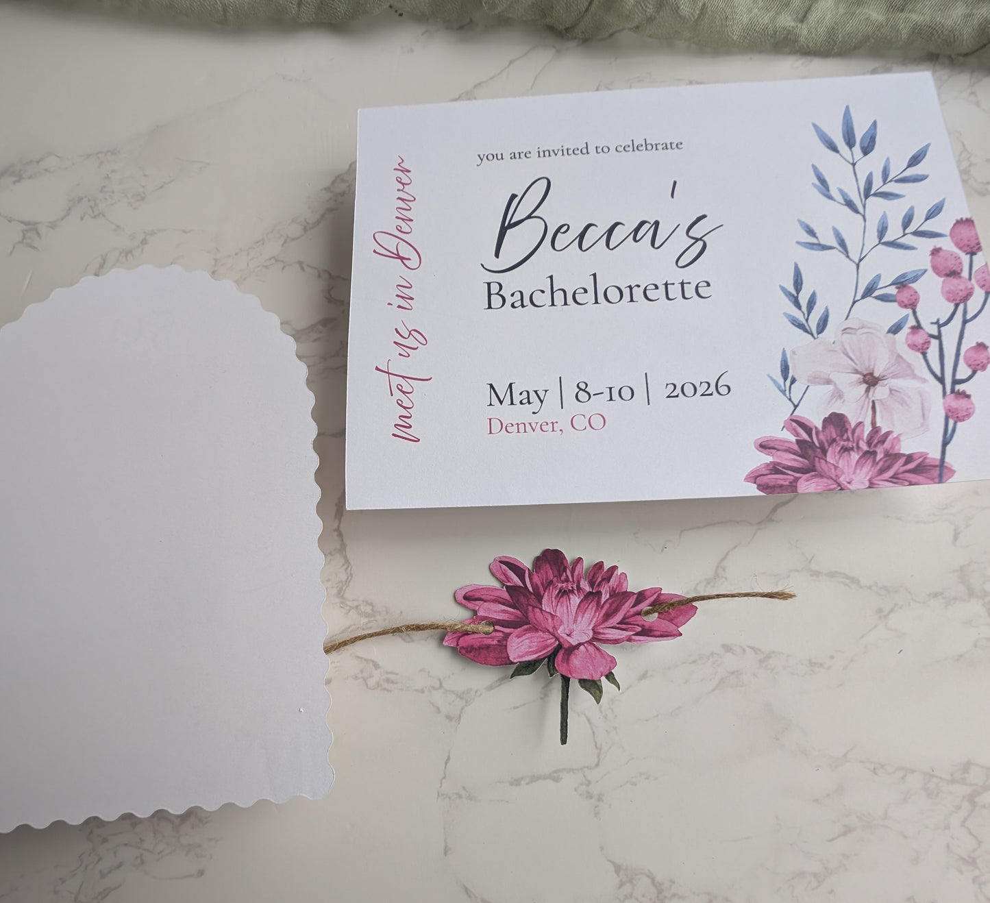 Bachelorette party invitation with floral design on a marble surface