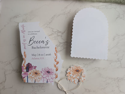 Bachelorette party invitation with floral design on a marble surface