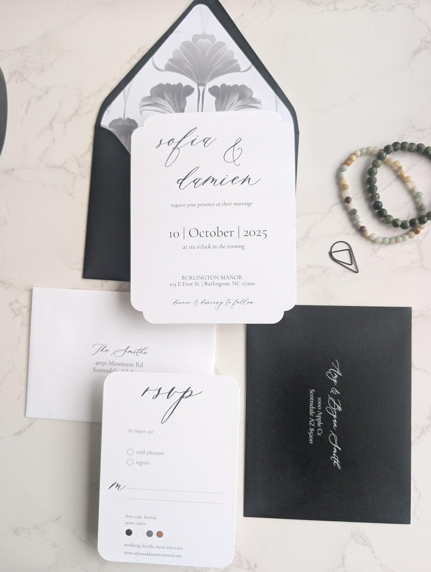 Wedding invitation set with black and white design on a light background
