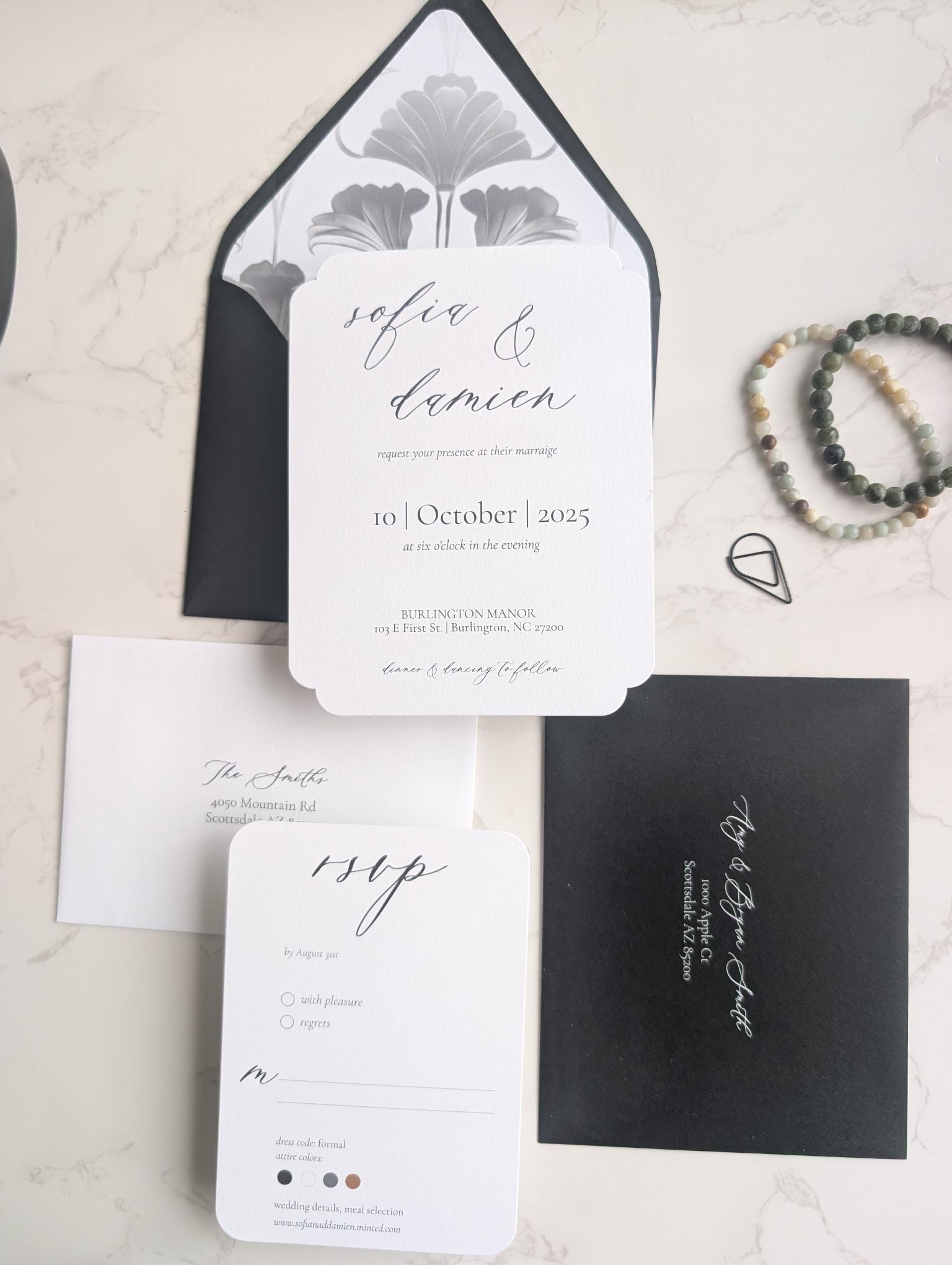 Wedding invitation set with black and white design on a light background