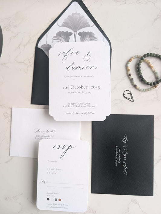 Wedding invitation set with black and white design on a light background