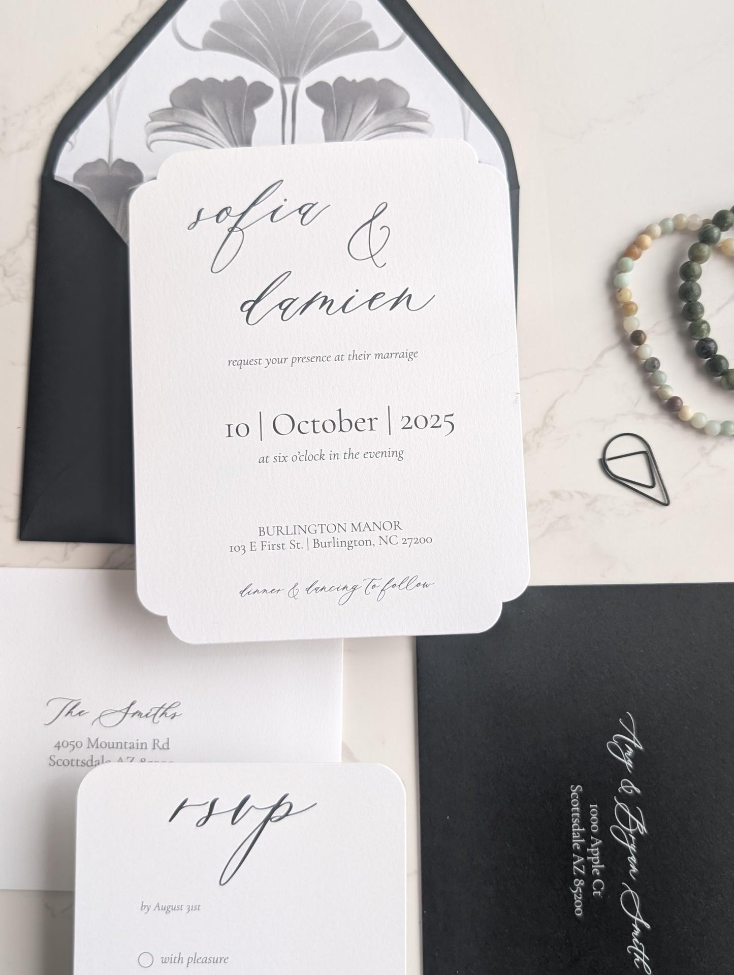 Wedding invitation set with black and white design on a light background
