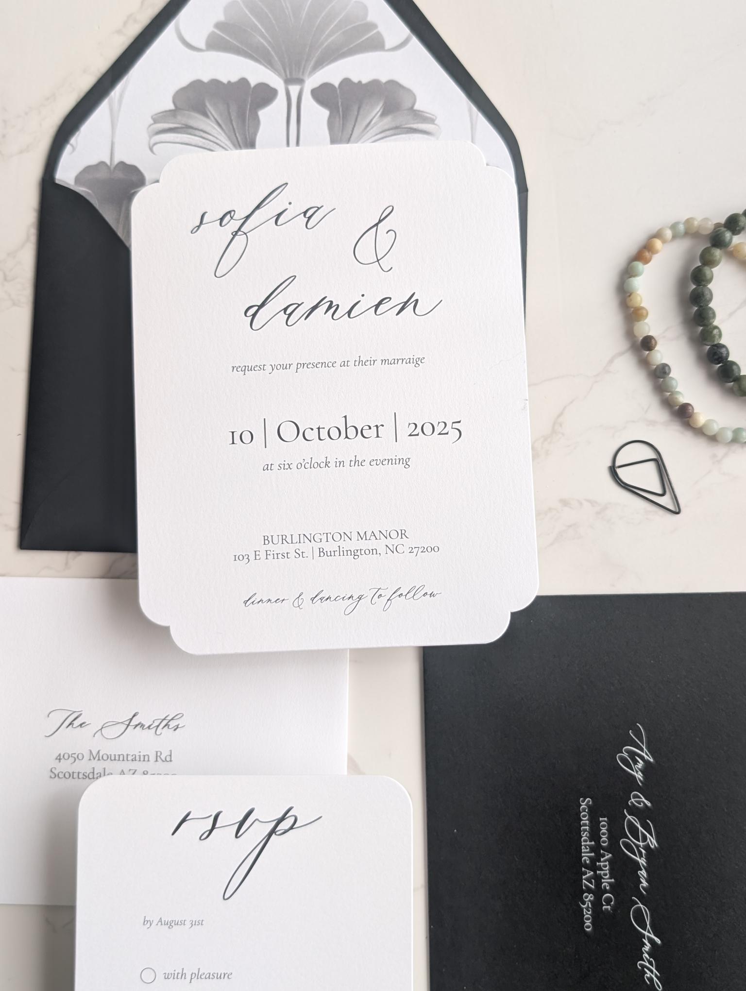Wedding invitation set with black and white design on a light background