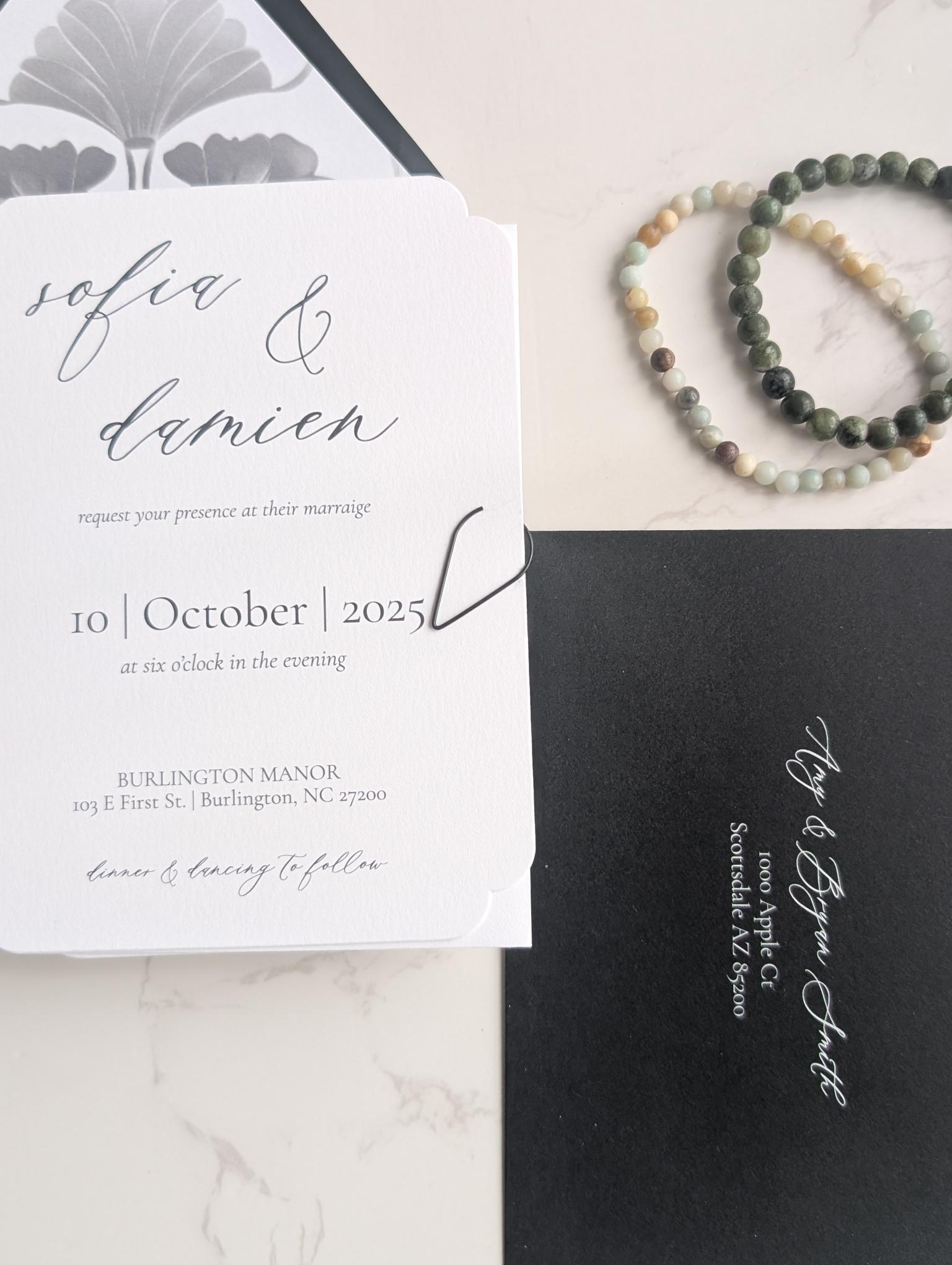 Wedding invitation card with RSVP card on a marble surface