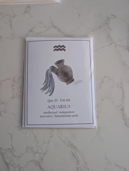 An Aquarius zodiac card or art print featuring a watercolor illustration of a clay jug with draped fabric, displayed on a light marble surface.