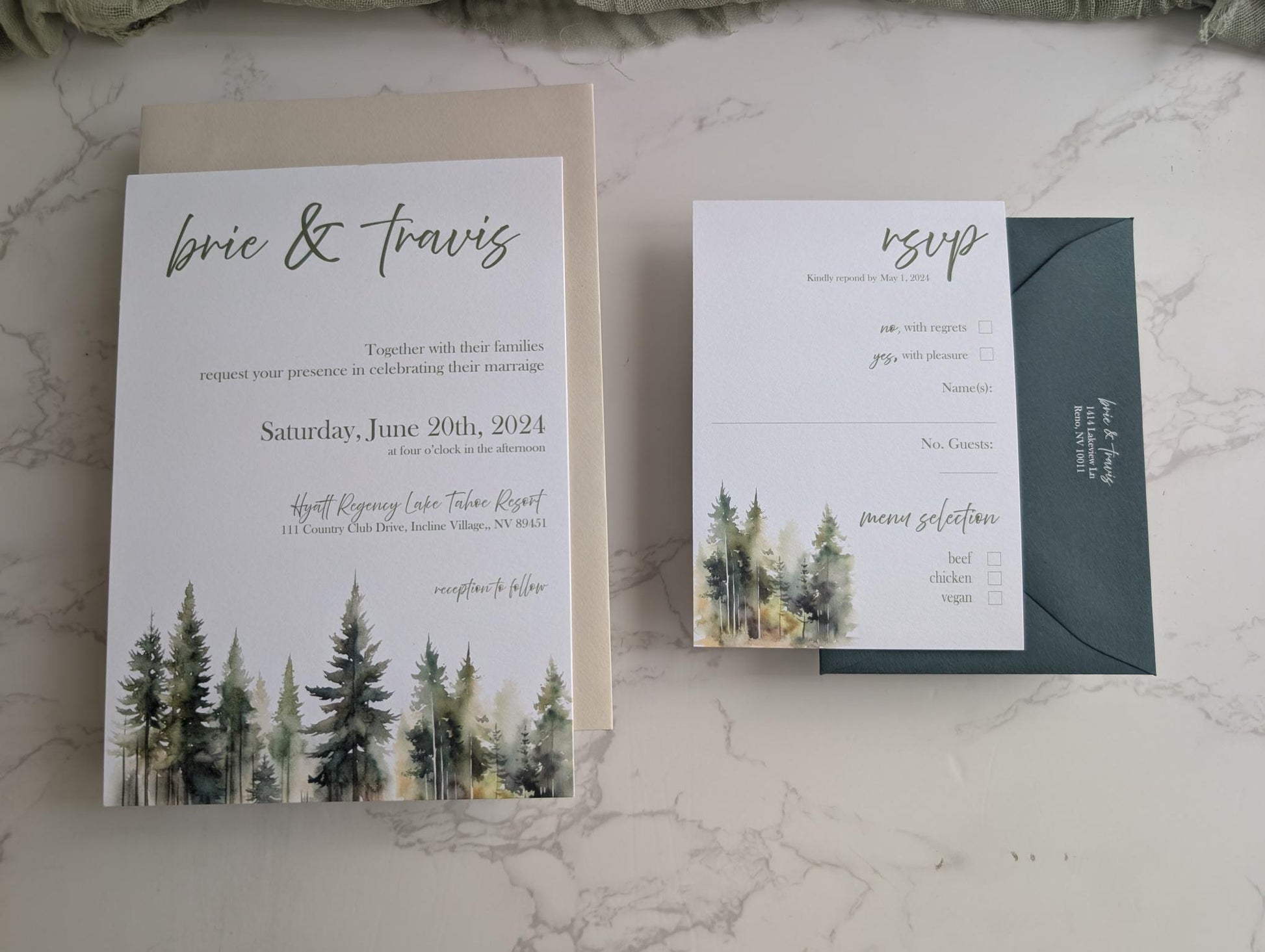 Wedding invitation with forest design and RSVP card on a marble surface
