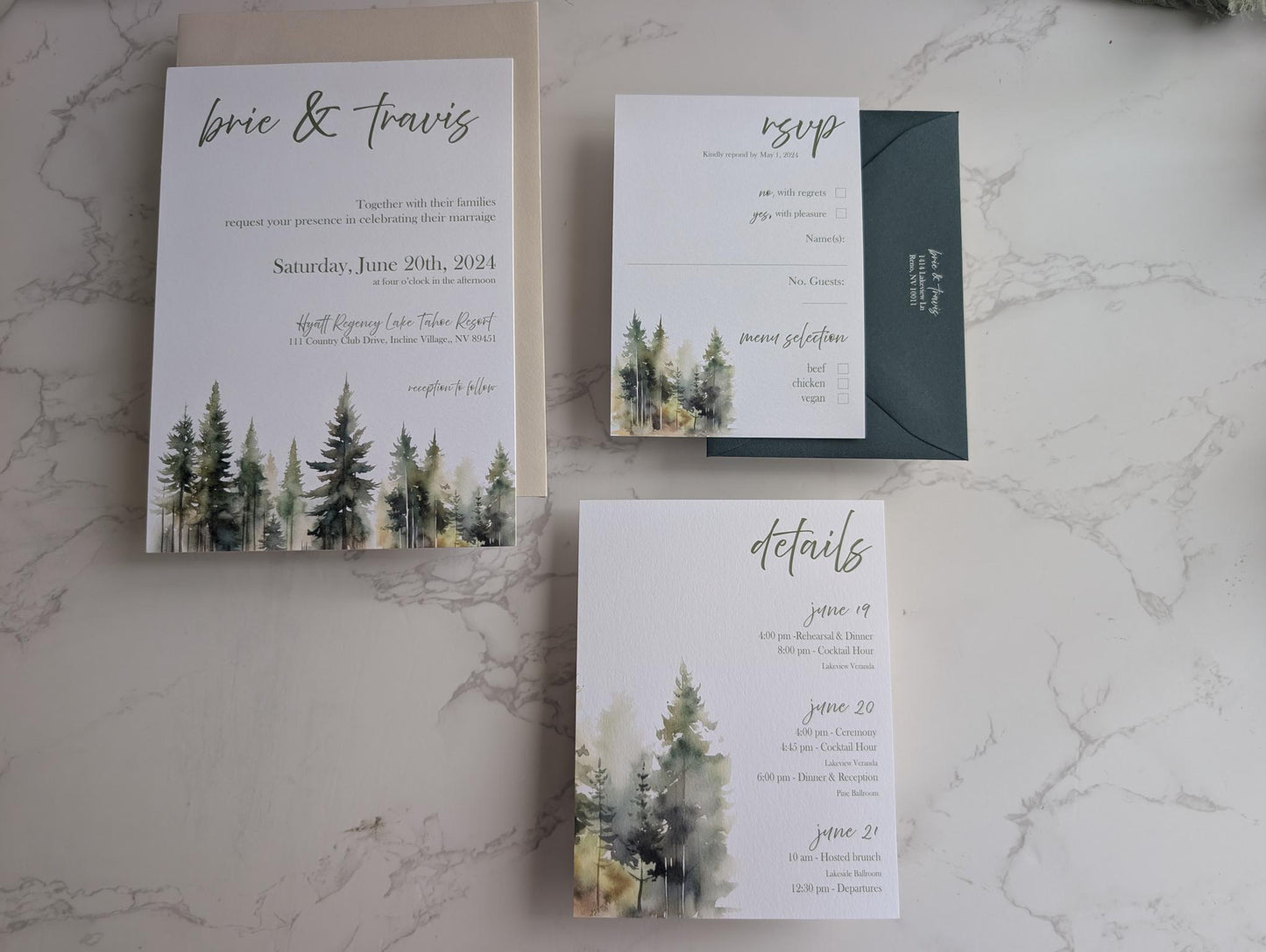 Wedding invitation set with trees on a marble surface