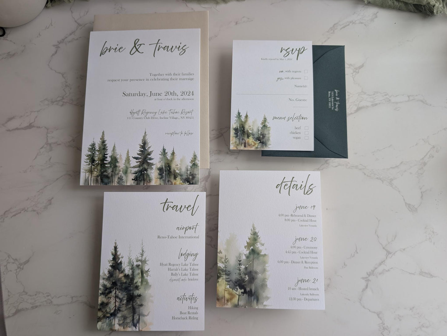 Wedding invitation set with forest design on a marble surface