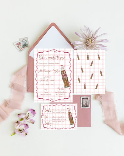 A styled flat-lay of a vintage-inspired bachelorette invitation suite, featuring a pink and white gingham invitation card with a retro cola bottle illustration, a matching invitation card, a pink envelope, and decorative pink ribbon and flowers on a white background.
