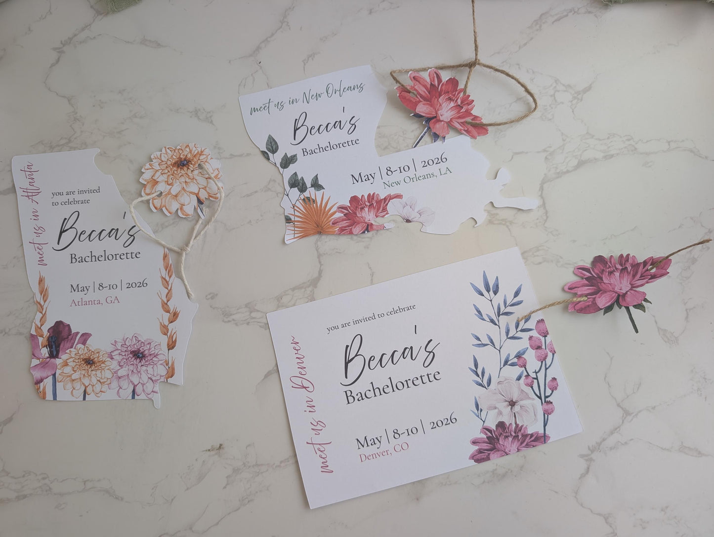 Bachelorette party invitations with floral designs on a marble surface