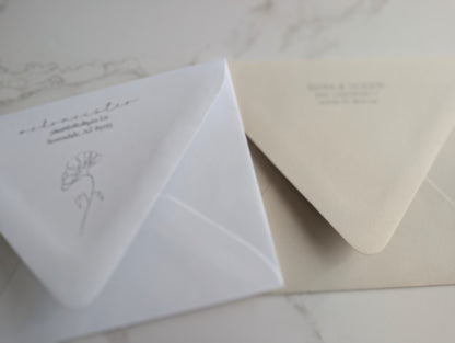Two envelopes with printed text on a marble surface