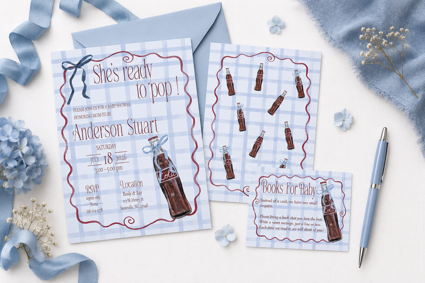 A styled flat-lay of a baby shower invitation suite with a vintage soda bottle theme. The set includes a main invitation card reading 'She's ready to pop!', an RSVP card, and a books for baby card, all featuring a light blue and white gingham pattern, red wavy borders, and illustrations of brown glass soda bottles.
