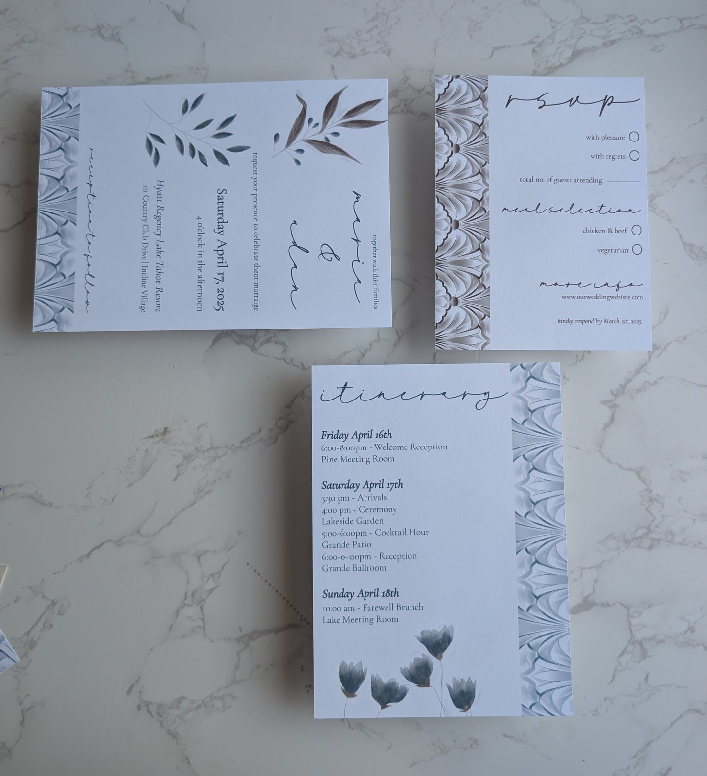 Set of wedding invitations with floral design on a marble surface