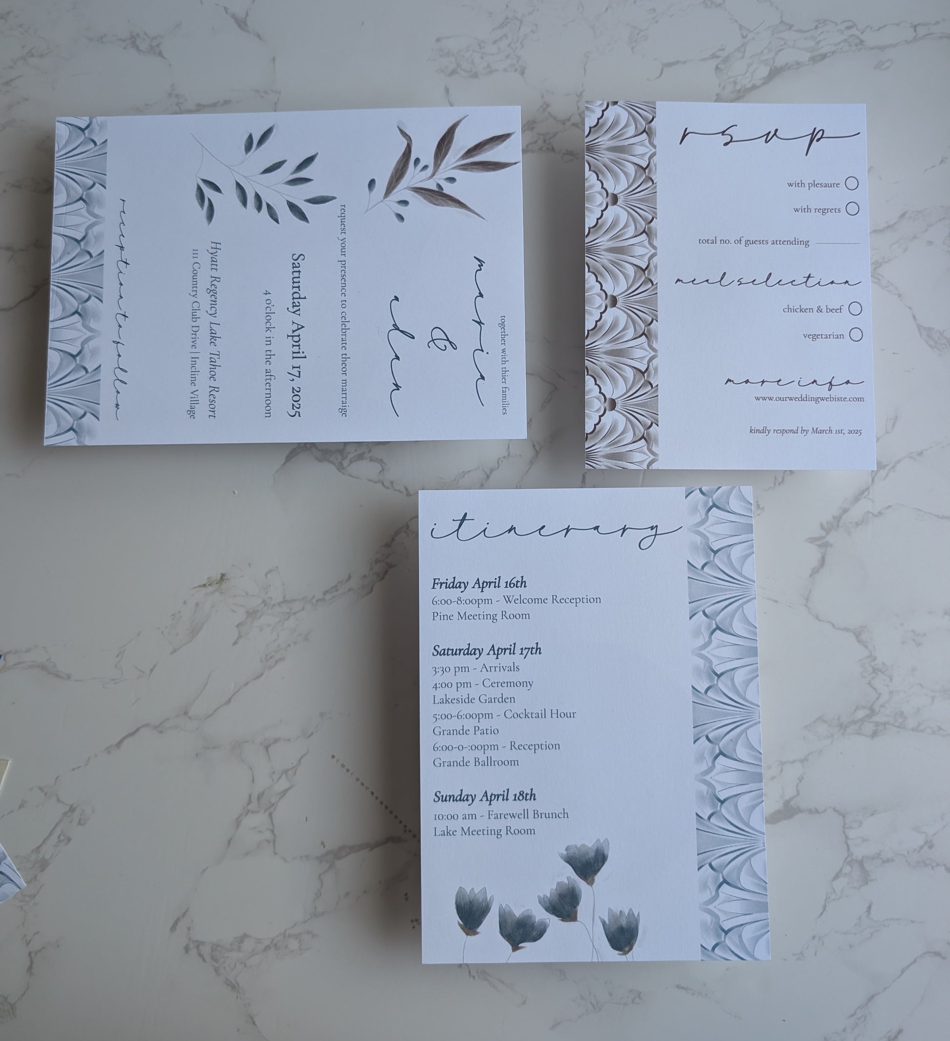 Set of wedding invitations with floral design on a marble surface
