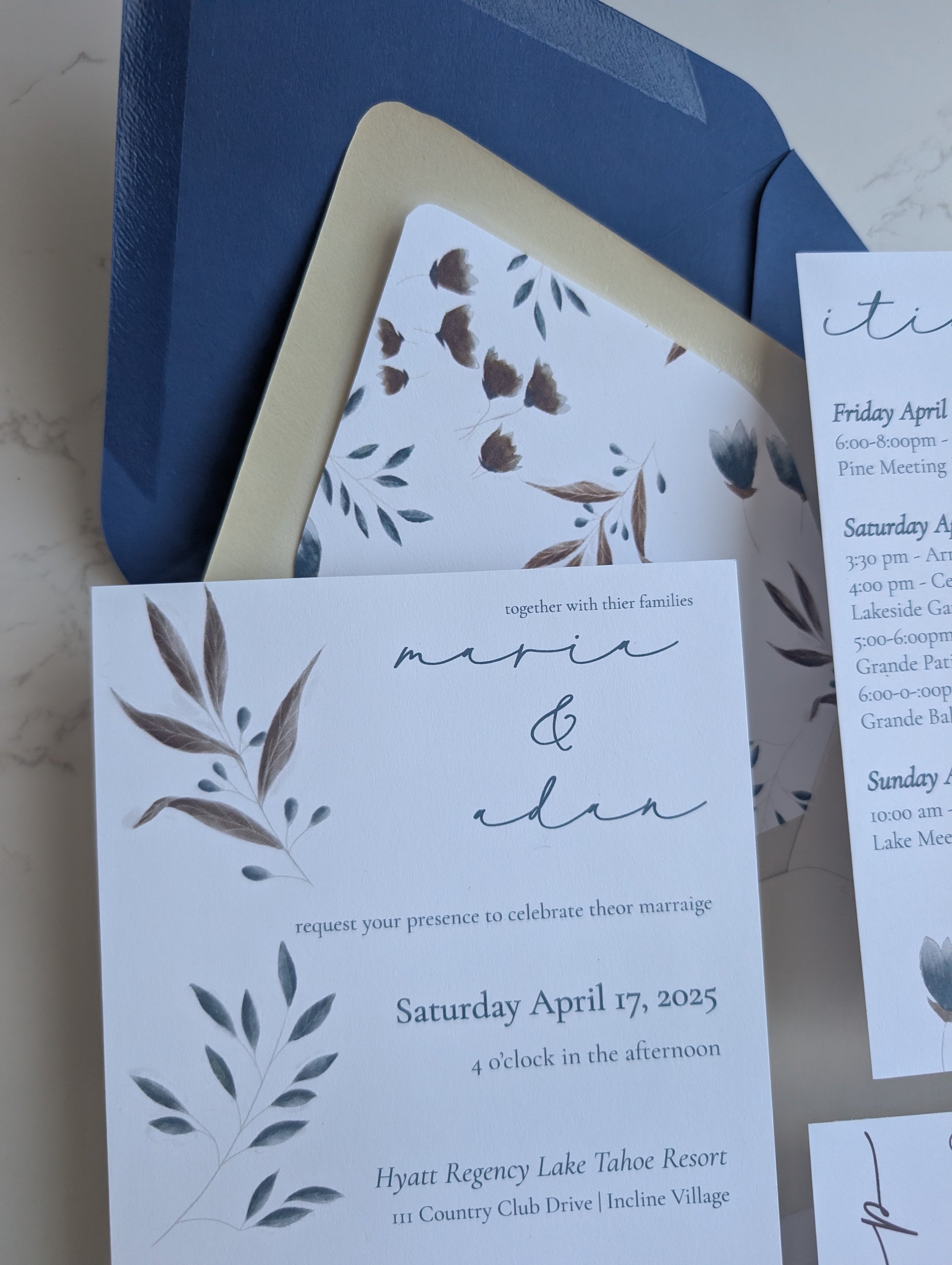 Wedding invitation with blue envelope and floral design