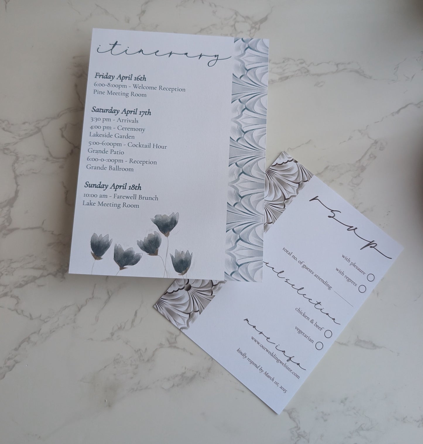 Wedding invitation set with floral design on a marble surface