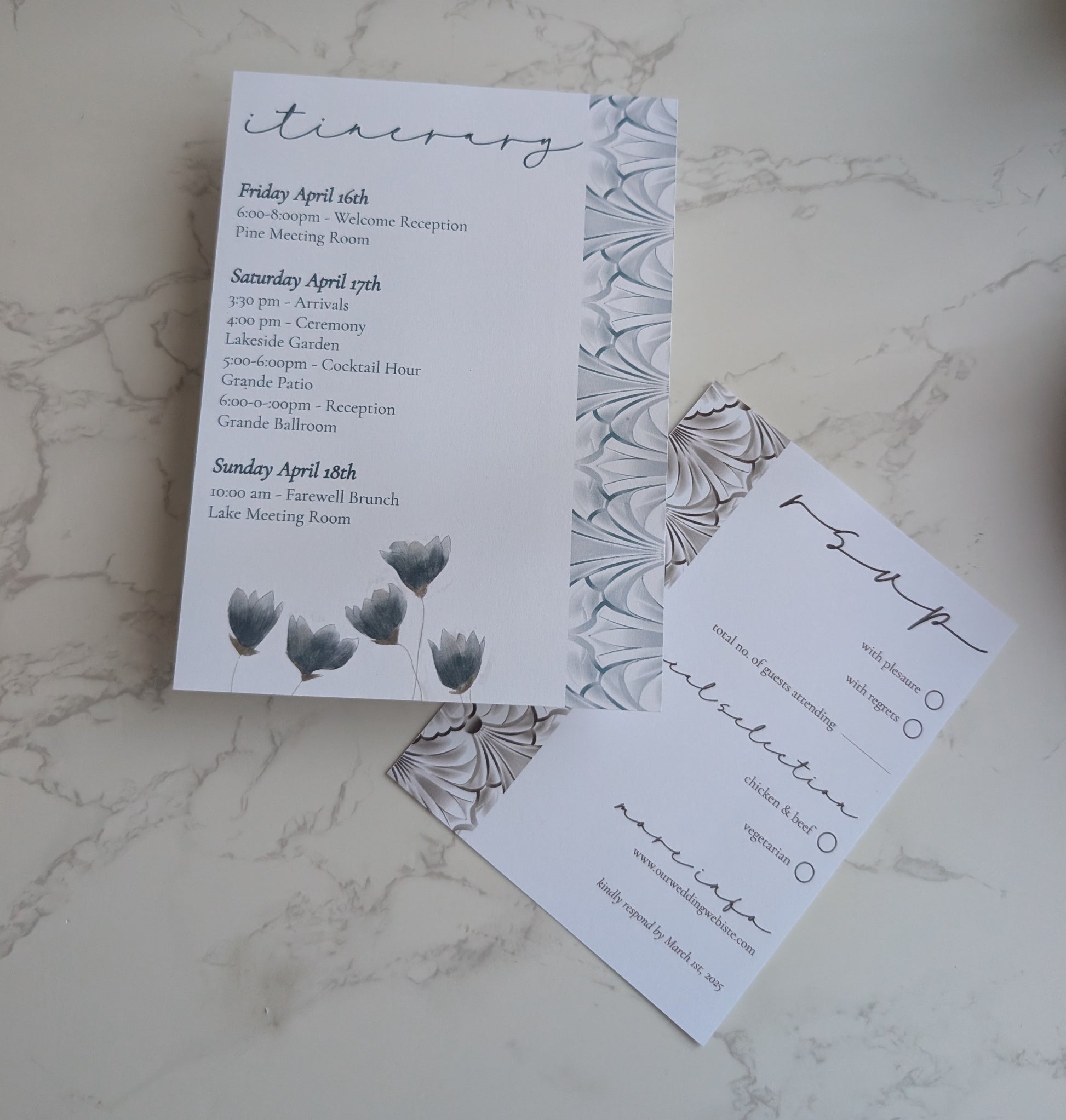 Wedding invitation set with floral design on a marble surface