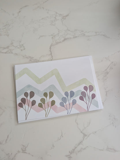 Card with floral design and zigzag pattern on a marble surface