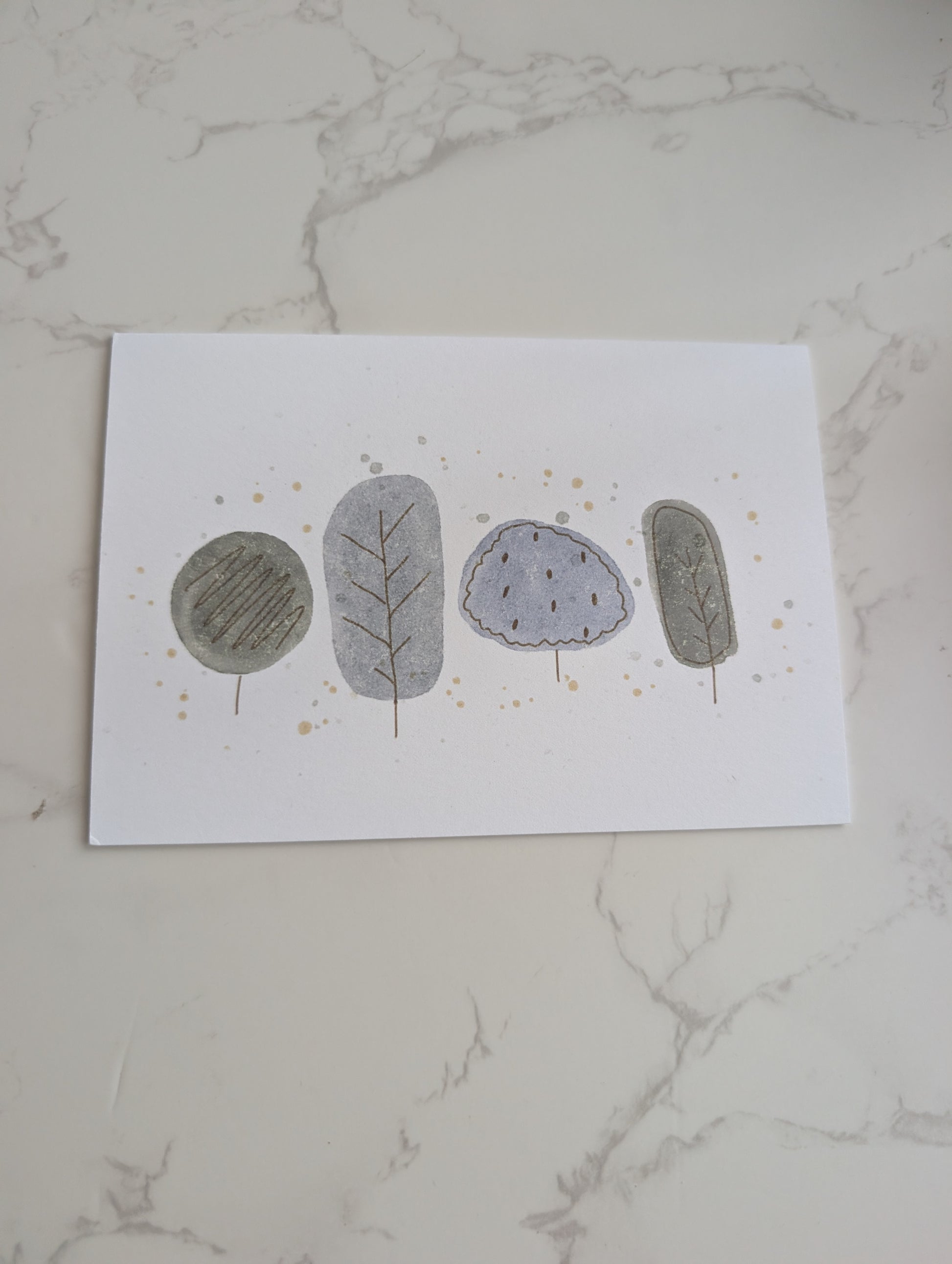 Four stylized stones with different textures on a white marble surface