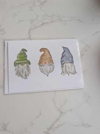 Three cartoon gnomes on a white card with a marble background