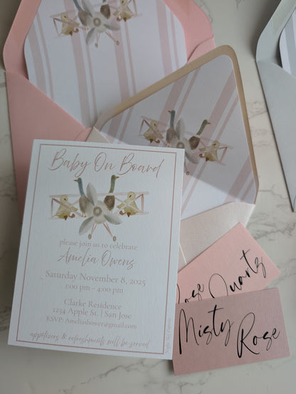 Baby shower invitation with floral design on a marble surface